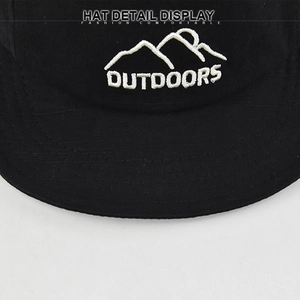 Close-up of white mountain embroidery and Outdoors text on a black cotton baseball cap