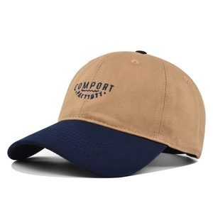 Two-tone beige and navy baseball cap with Comfort 1977 embroidery and curved brim