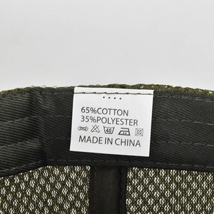 Detail view of cotton blend camouflage cap inner mesh lining and washing instruction label