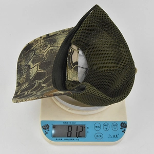 Camo tactical baseball cap weighing 81.2g on an electronic scale for weight demonstration