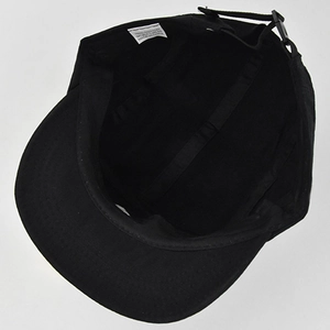 Detail view of the interior construction and adjustable buckle strap of the black cotton hat