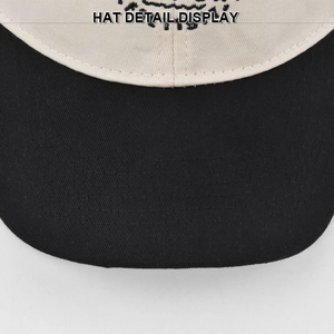 Macro detail of COMPORT embroidery on two-tone cotton baseball cap with neat stitching