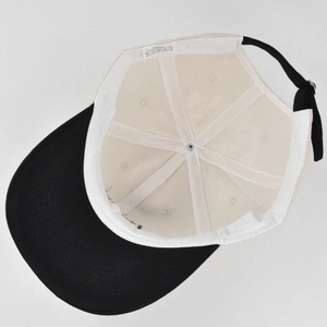 Interior view of embroidered baseball cap showing 100% cotton material and stitching