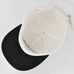 Detail view of cotton baseball cap interior showing 100% cotton tag and embroidery