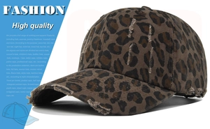 Close-up of distressed leopard print fabric with vintage ripped details on baseball cap