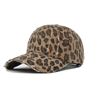 Detail of leopard print baseball cap with distressed torn edges and vintage washed canvas