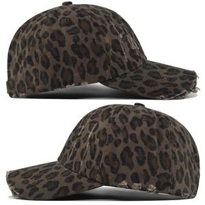Close-up of leopard print baseball cap with vintage distressed holes and washed canvas fabric