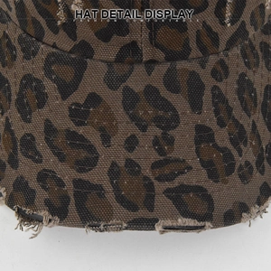 Detail view of leopard print baseball cap featuring distressed torn edges and fabric texture
