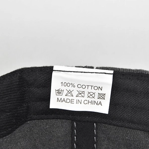 Detail of the 100% cotton material label on the vintage washed baseball cap
