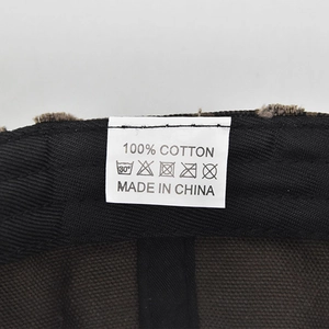 Detail shot of internal 100% cotton tag and black striped lining on leopard baseball cap