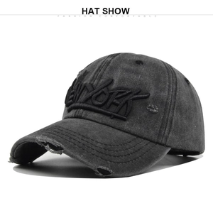 Close-up of 3D New York embroidery and distressed frayed details on a charcoal baseball cap