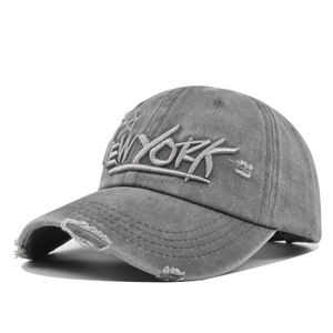 Close-up of vintage grey baseball cap featuring 3D New York embroidery and distressed details