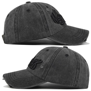 Detail view of vintage charcoal grey baseball cap with New York embroidery and distressed rips