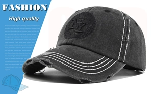 Close-up of vintage washed denim baseball cap with NY embroidery and contrast white stitching