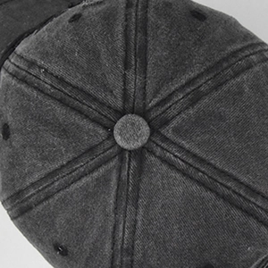 Detail view of washed denim baseball cap top with six-panel stitching and top button