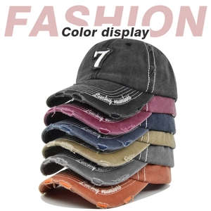 Vertical stack of vintage washed baseball caps with number 7 embroidery in six colors