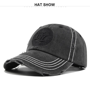 Detail shot of distressed dark gray baseball cap with 3D NY embroidery and frayed edges