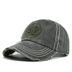 Close-up of vintage grey baseball cap with NY embroidery and distressed denim texture