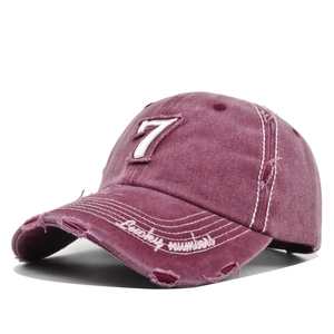 Close-up of distressed cotton baseball cap with number 7 patch and Lucky Numbers embroidery
