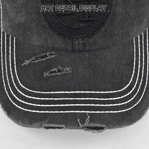 Detailed close-up of distressed brim on charcoal grey washed cotton baseball cap