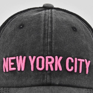 Detail of vintage washed baseball cap featuring 3D pink New York City embroidery