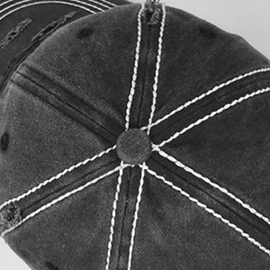 Close-up of vintage distressed grey baseball cap with contrast stitching and frayed details