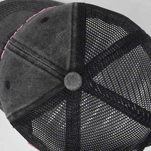 Detail view of washed canvas texture and mesh back on the vintage baseball cap