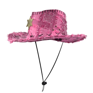 Detail of pink frayed cowboy hat with golden Sheriff star badge and black stitch brim