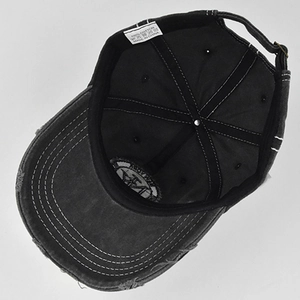 Detail view showing 100% cotton material label and internal stitching of the NY baseball cap