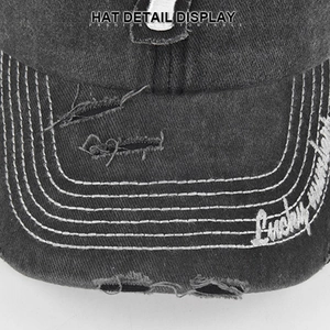Detailed close-up of distressed brim on vintage washed denim baseball cap with embroidery
