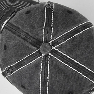 Detail of vintage washed baseball cap showing white contrast stitching and six-panel crown