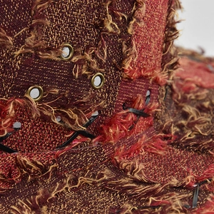 Detail of distressed woven texture and metal eyelets on a vintage western cowboy hat