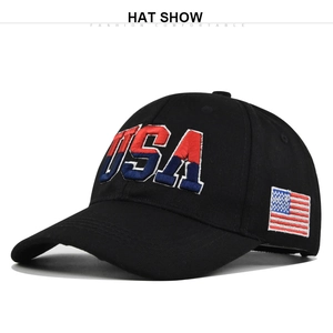 Close-up of 3D USA embroidery and American flag patch on a black cotton baseball cap