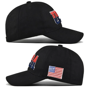 Detailed side view of 3D USA embroidery and American flag patch on a black cotton baseball cap