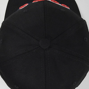 Top view of a black six-panel cotton baseball cap showing texture and stitching details