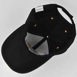 Detail view of internal six-panel stitching and white fabric care label inside the black cap