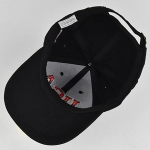 Detail view of cotton baseball cap interior with stitching and metal adjustment buckle