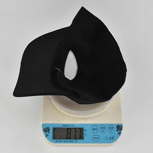 Detailed view of the black cotton baseball cap on a scale showing 87.7g product weight