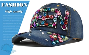 Detailed view of colorful teardrop rhinestones on dark blue denim baseball cap