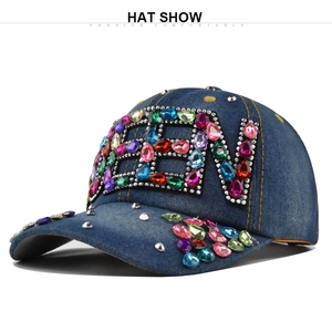 Detailed macro view of colorful rhinestones and gemstones forming NEW on blue denim cap