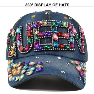 Front view of dark blue denim baseball cap featuring colorful rhinestone QUEEN letters