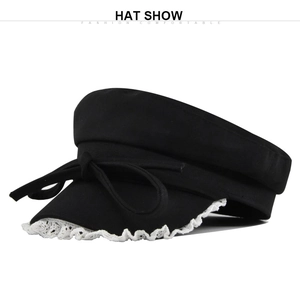 Detail of black navy sailor hat with bow tie and delicate white lace brim trim