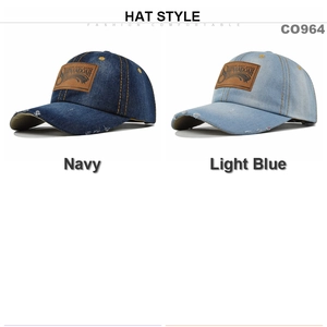 Close-up of navy and light blue distressed denim caps with vintage brown leather patches