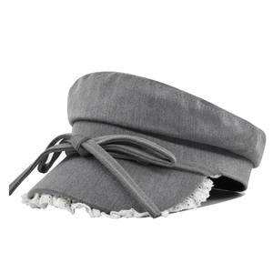 Detail of grey flat top hat featuring white lace trim and a decorative ribbon bow