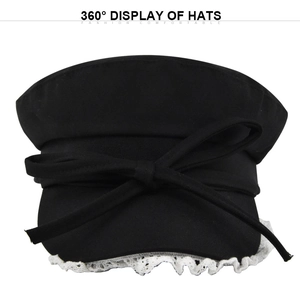 Detail of black newsboy hat featuring elegant white lace trim and a sweet ribbon bow