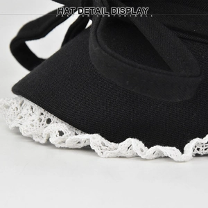 Lace-trimmed black sun hat with bow detail and white crochet edges in a diagonal view