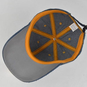 Detail view of cotton baseball cap interior featuring orange seam tape and logo tag