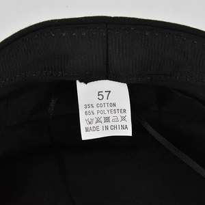 Detail view of the black beret wash label showing size 57 and fabric composition