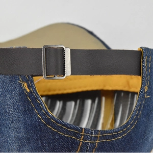 Adjustable distressed blue denim baseball cap featuring leather strap and metal buckle detail