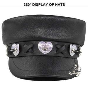 Detail of punk leather beret featuring holographic hearts and metal ring accents